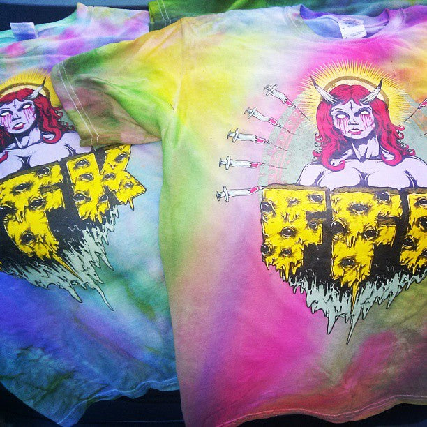 Tie-dye t-shirt with graphic design featuring a woman with horns and the letters 'FFK' on a colorful background.