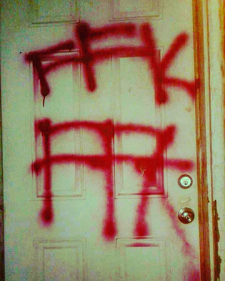 Red spray paint on a door that says FFK