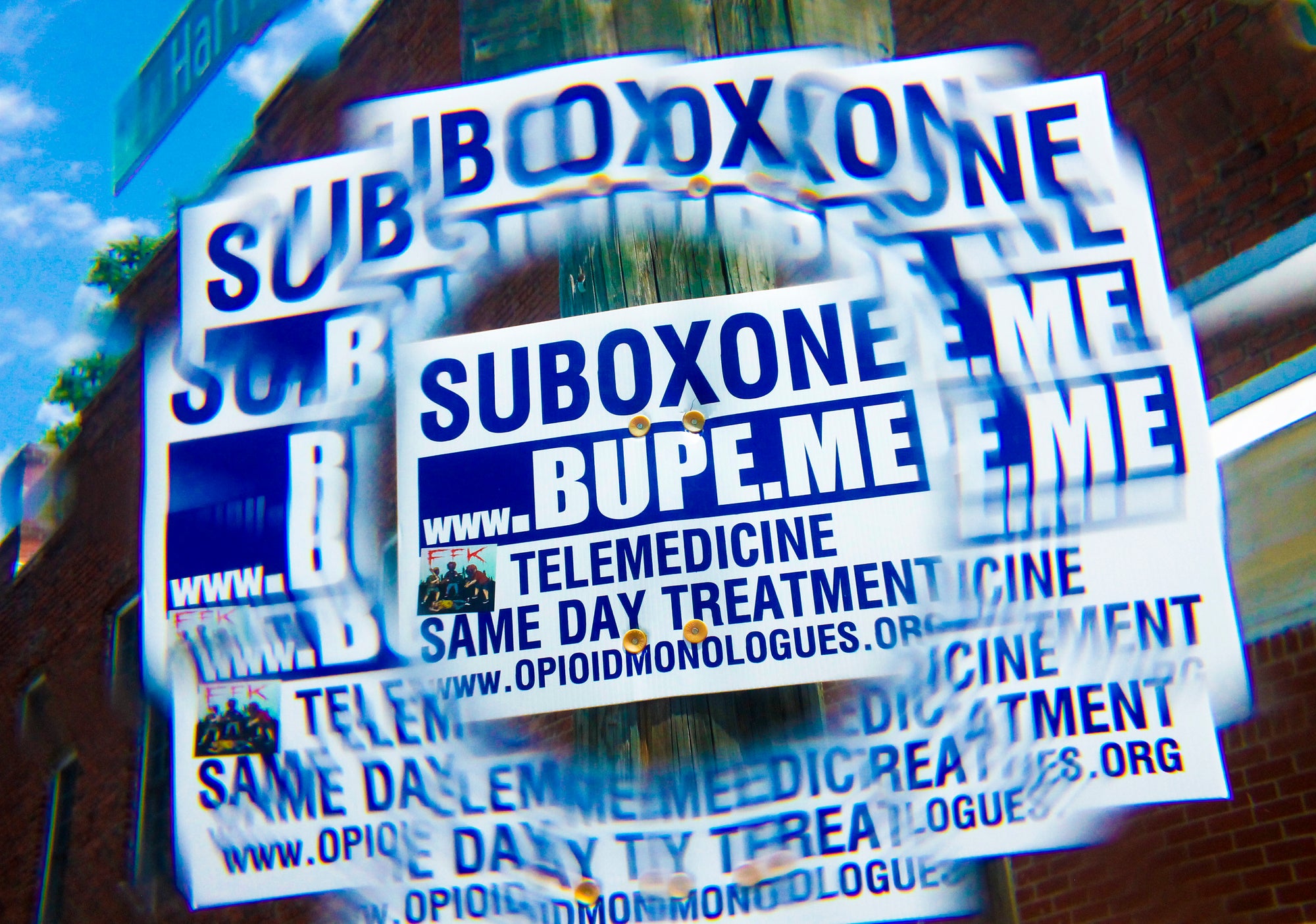 SUBOXONE advertisements on a street sign with reflections and a FFK sticker.