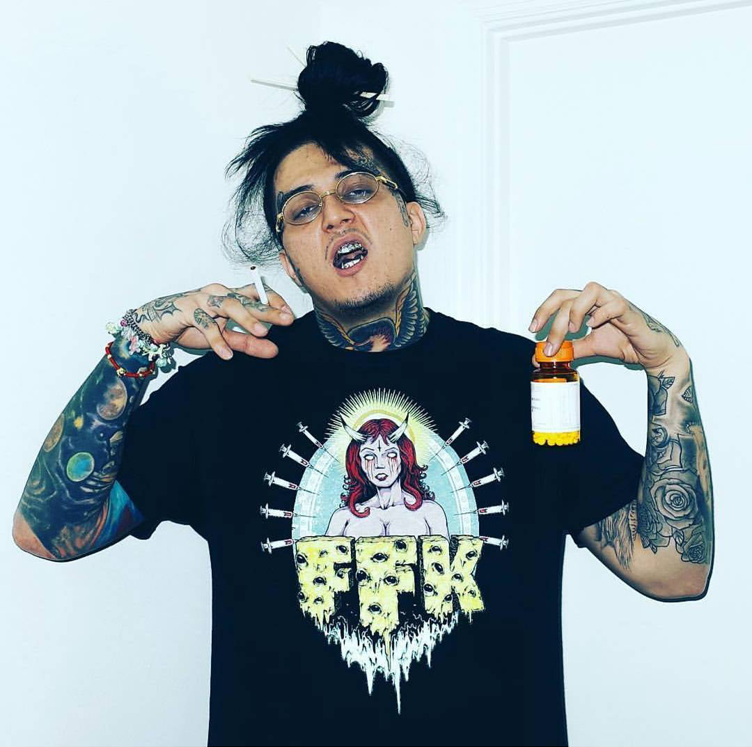 Sosmula from City Morgue wearing a FFK Shirt with a pill bottle in his hand